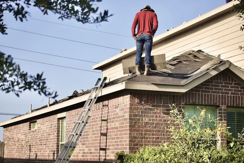 Professional roofer working on a residential roof in Rosaryville Estates
